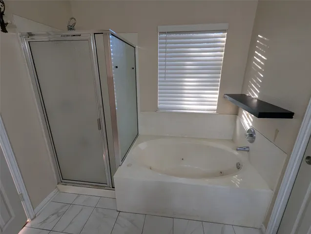 a white bath tub sitting next to a window