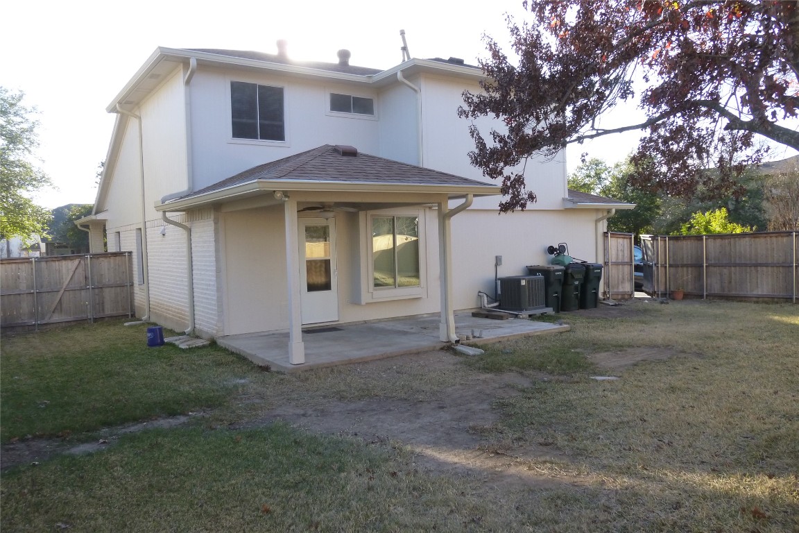1016 Stacia's Way Pflugerville, TX 78660 - Photo 30 of 34 Back of property with a wood privacy fenced yard, covered patio