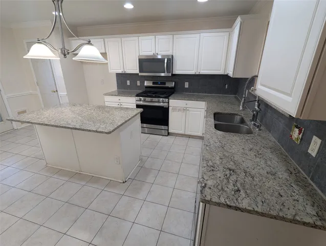 a kitchen with stainless steel appliances granite countertop a sink stove and cabinets