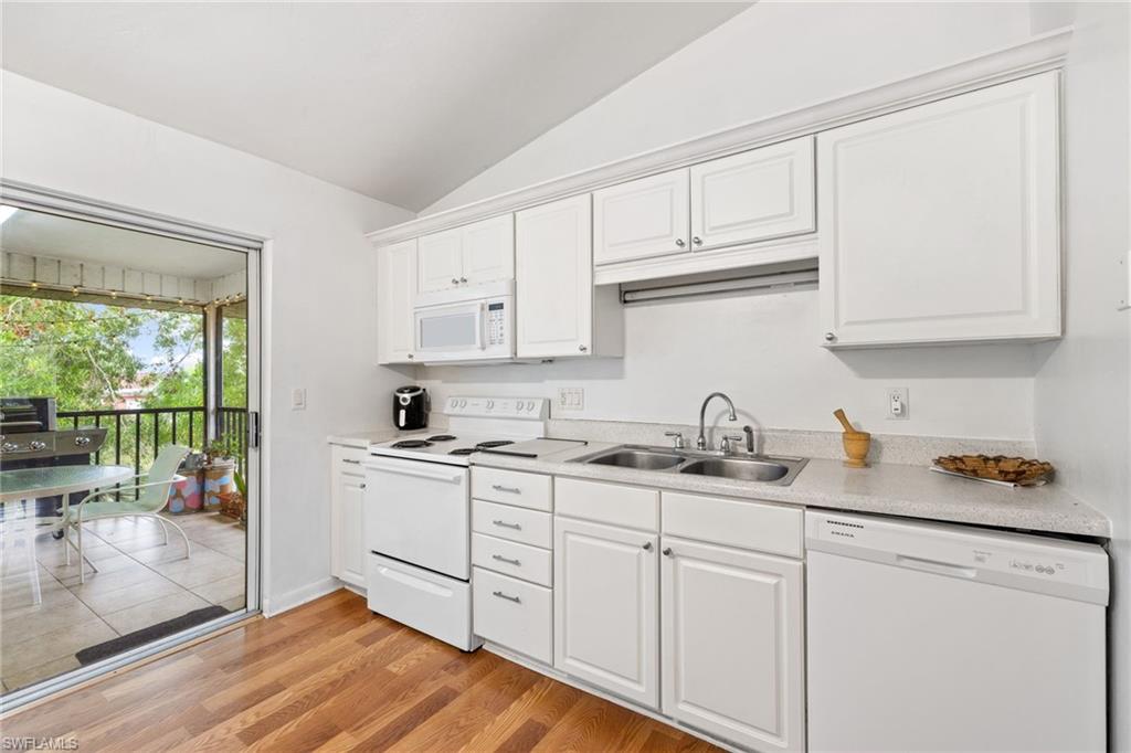 5406 16th Place Southwest, Unit E4 Naples, FL 34116 - Photo 14 of 26 a kitchen with stainless steel appliances granite countertop a sink stove and cabinets