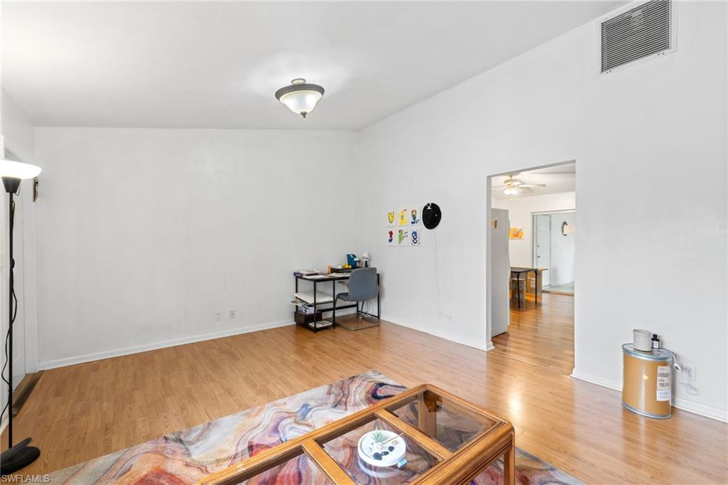 5406 16th Place Southwest, Unit E4 Naples, FL 34116 - Photo 17 of 26 a living room with furniture and wooden floor