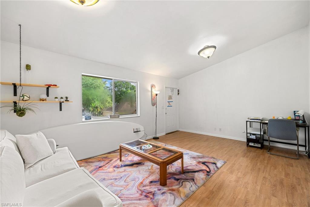 5406 16th Place Southwest, Unit E4 Naples, FL 34116 - Photo 18 of 26 a living room with a bed furniture and a window