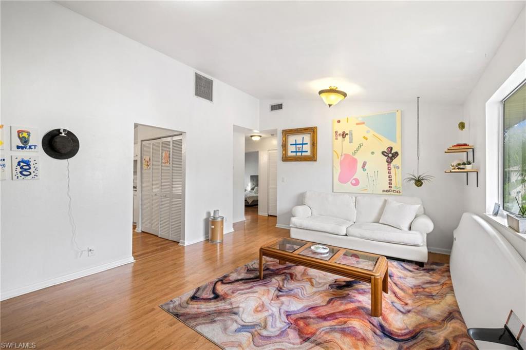 5406 16th Place Southwest, Unit E4 Naples, FL 34116 - Photo 19 of 26 a living room with furniture and wooden floor
