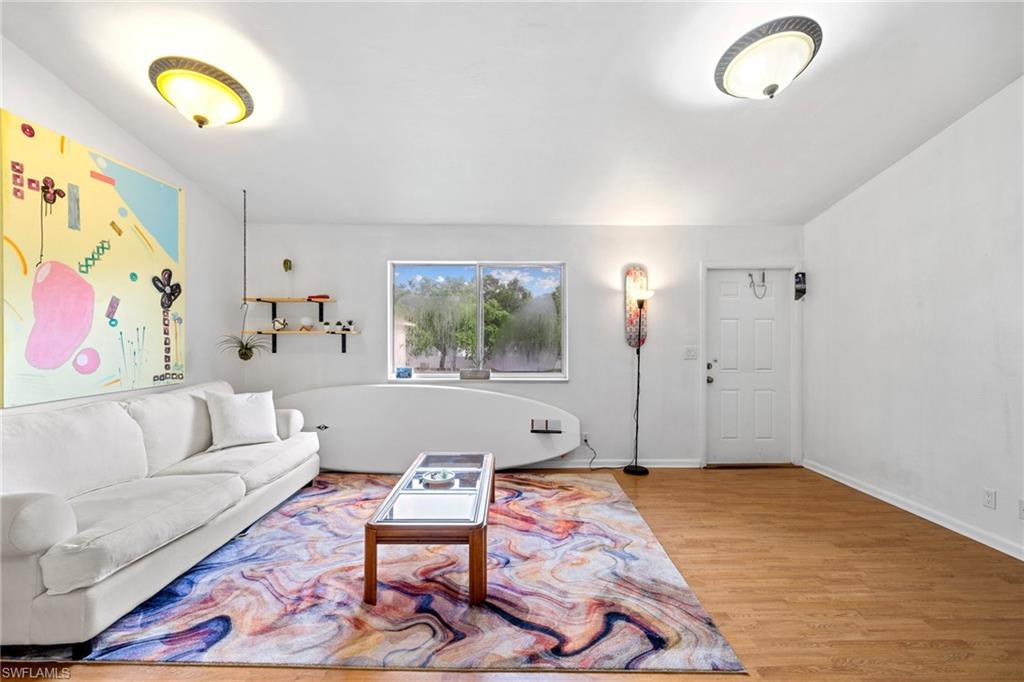 5406 16th Place Southwest, Unit E4 Naples, FL 34116 - Photo 20 of 26 a living room with furniture and a flat screen tv