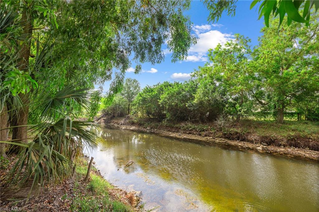 5406 16th Place Southwest, Unit E4 Naples, FL 34116 - Photo 2 of 26 an aerial view of residential houses with outdoor space and trees