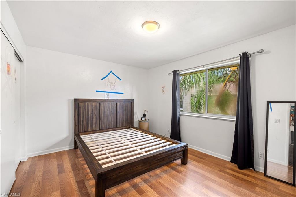 5406 16th Place Southwest, Unit E4 Naples, FL 34116 - Photo 25 of 26 a bedroom with a bed and a window