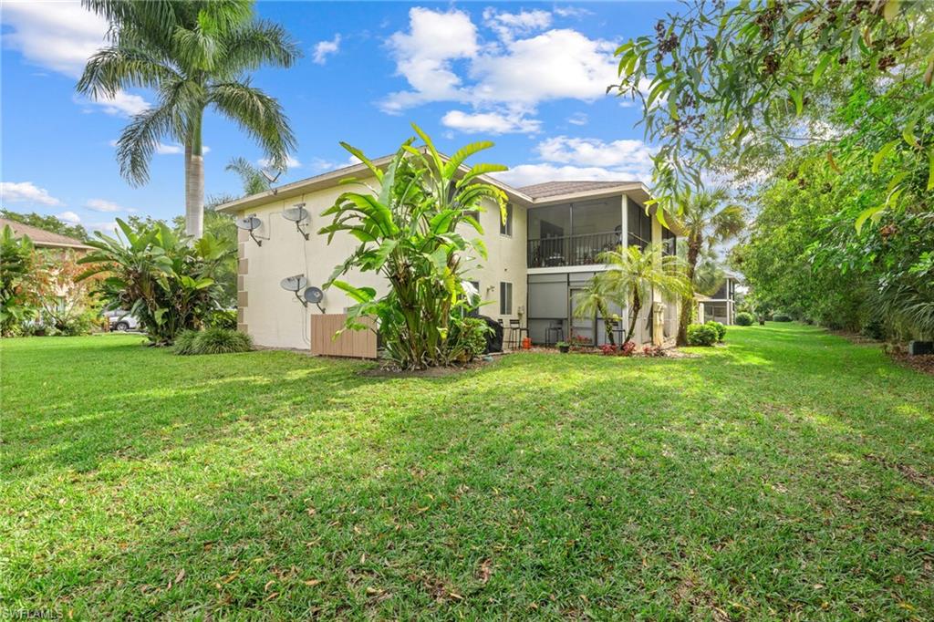 5406 16th Place Southwest, Unit E4 Naples, FL 34116 - Photo 3 of 26 a view of a house with a backyard