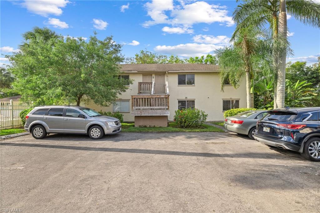 5406 16th Place Southwest, Unit E4 Naples, FL 34116 - Photo 5 of 26 a view of a car parked in front of a house