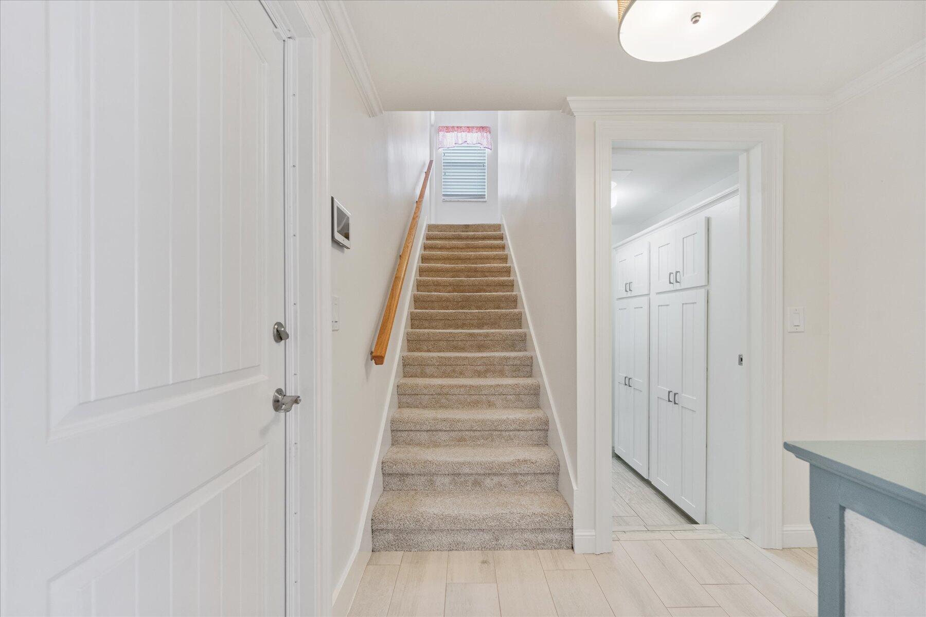 1180 Singer Drive Singer Island, FL 33404 - Photo 19 of 24 a view of an entryway with staircase