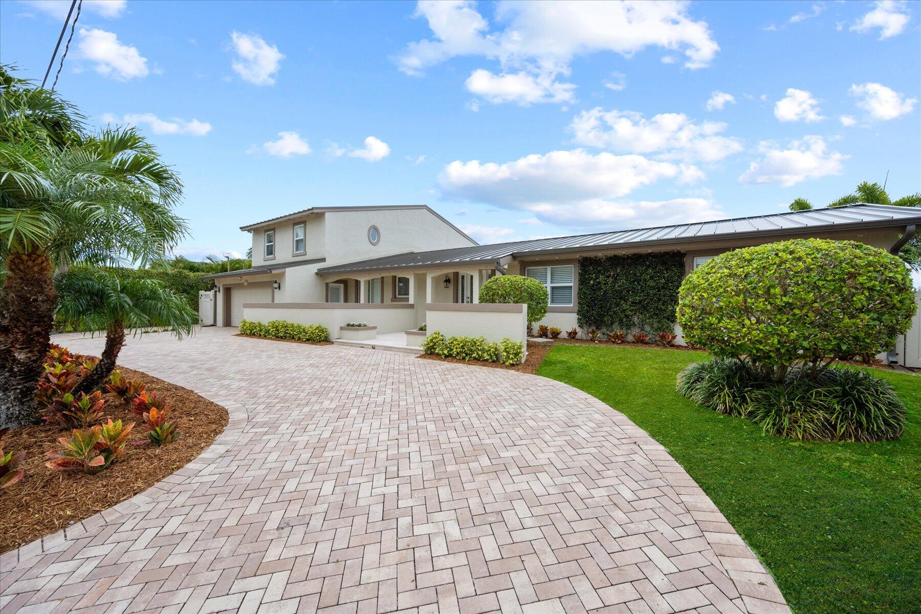 1180 Singer Drive Singer Island, FL 33404 - Photo 24 of 24 a front view of a house with a yard