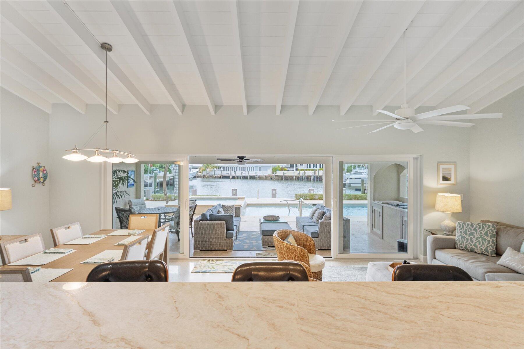 1180 Singer Drive Singer Island, FL 33404 - Photo 7 of 24 a bedroom with furniture and a large window