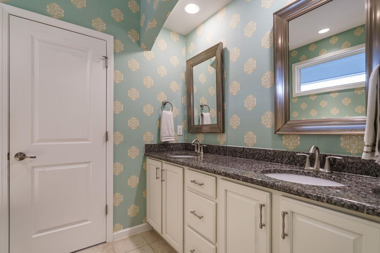 5602 Wade Park Boulevard Raleigh, NC 27607 - Photo 28 of 34 Spa like setting in this owner's suite bath. Dual granite top vanity, tiled floors and glass enclosed shower. Garden tub and lots of natural light! Owner's Bath