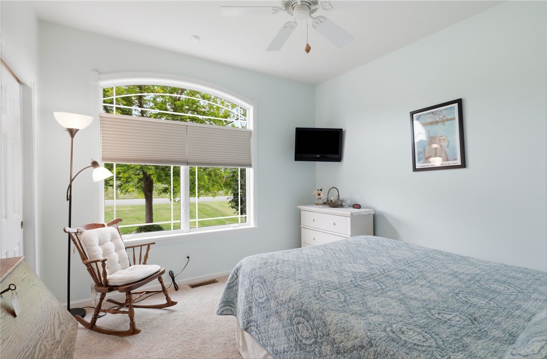 4536 Crystal Ridge Circle Gorham, NY 14424 - Photo 27 of 48 The second bedroom features expansive, elegant arched windows that allow an abundance of soft, natural sunlight.
