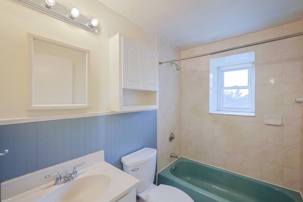 16 Erick Road, Unit 34 Mansfield, MA 02048 - Photo 8 of 14 a bathroom with a sink mirror and toilet