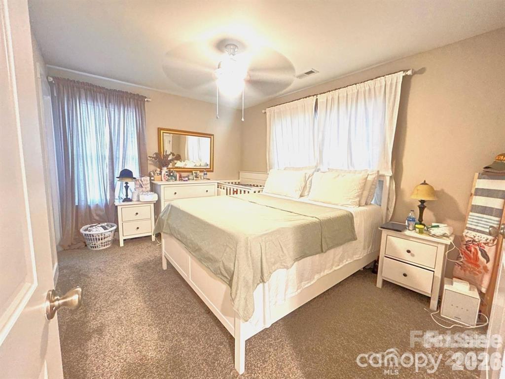 606 East Carpenter Street Dallas, NC 28034 - Photo 8 of 9 a bed room with a bed and a chair