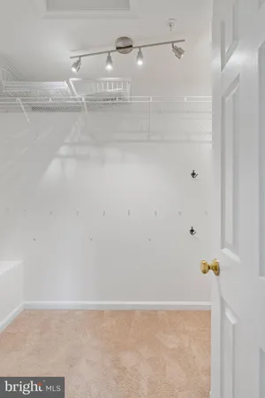 an empty room with windows and closet