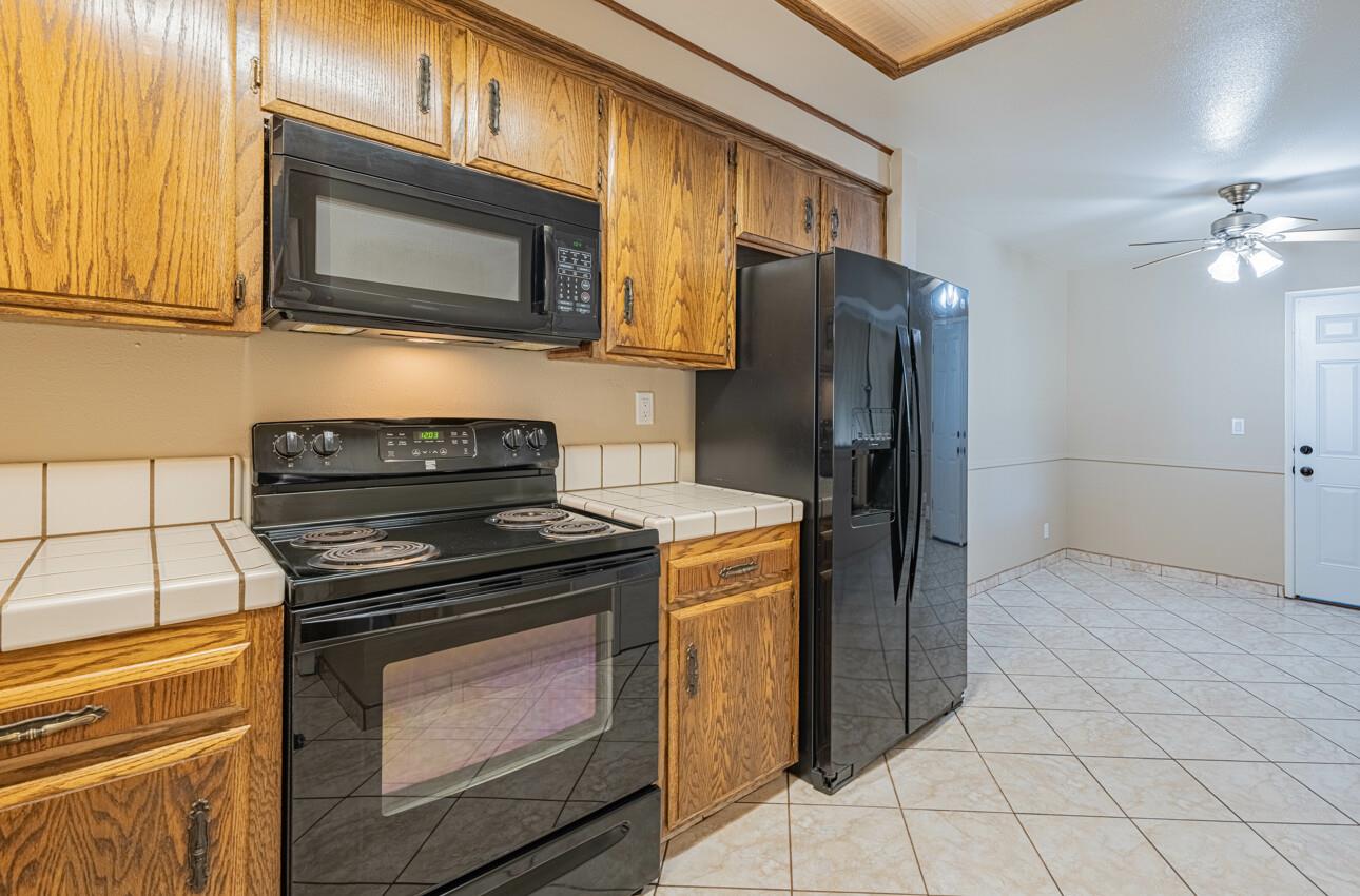 1840 Cherokee Drive, Unit 1 Salinas, CA 93906 - Photo 15 of 32 a kitchen with stainless steel appliances granite countertop a stove microwave and refrigerator