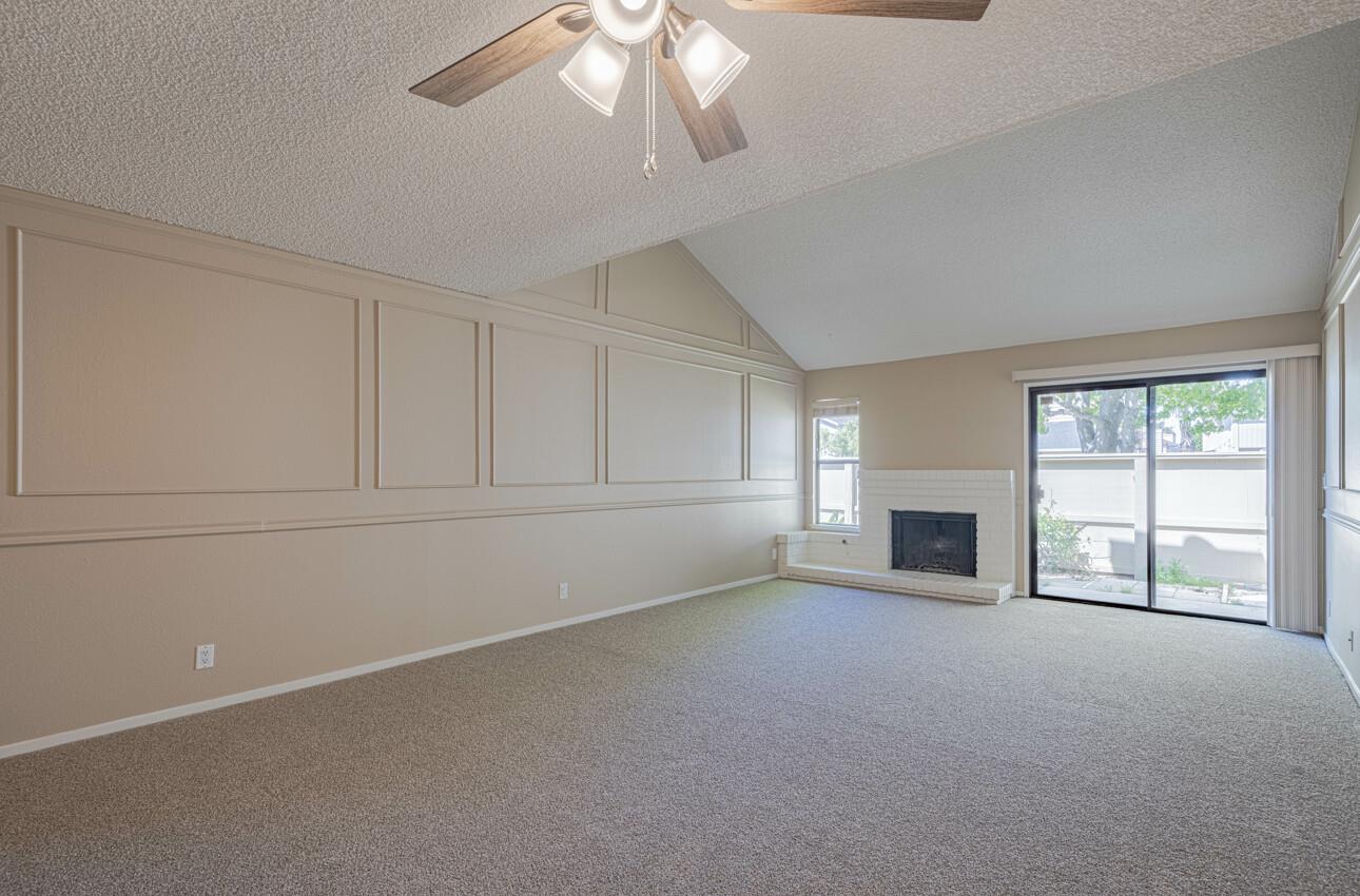 1840 Cherokee Drive, Unit 1 Salinas, CA 93906 - Photo 5 of 32 an empty room with chandelier fan and windows