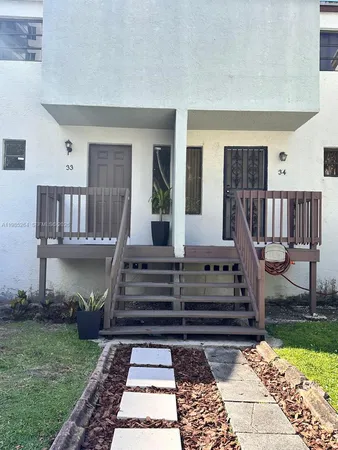 a view of a balcony with two chairs and a rug