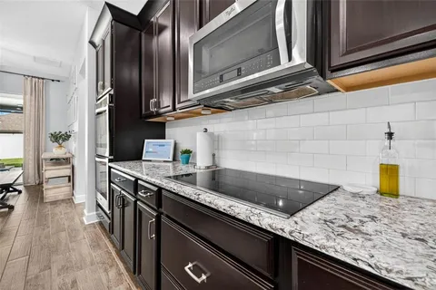 a kitchen with stainless steel appliances granite countertop a sink and stove