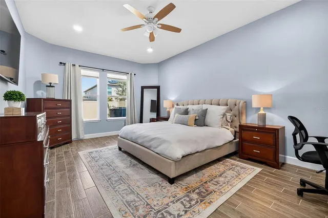 a bedroom with a large bed and a chandelier