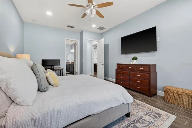 a bedroom with a bed and a flat screen tv