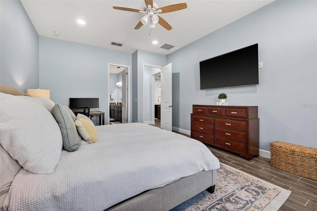 10522 Cardera Drive Riverview, FL 33578 - Photo 20 of 43 a bedroom with a bed and a flat screen tv