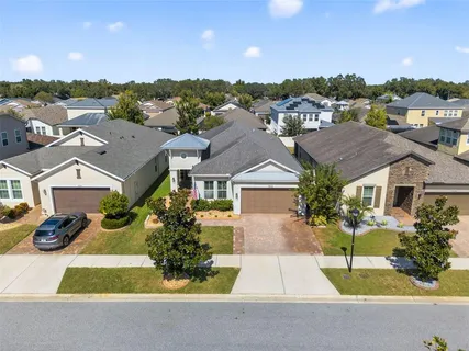 an aerial view of a city with lots of residential buildings and mountain view in back