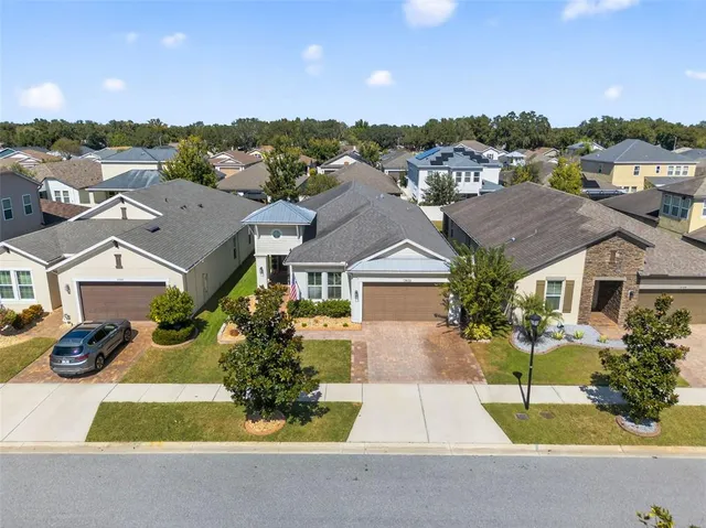 an aerial view of a city with lots of residential buildings and mountain view in back