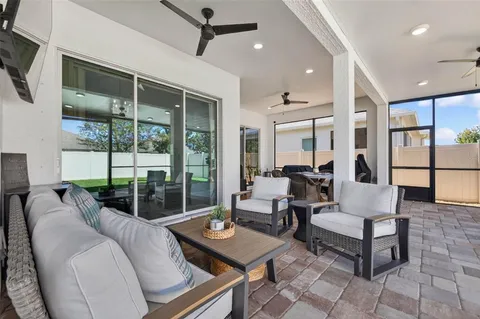 a living room with furniture and a floor to ceiling window