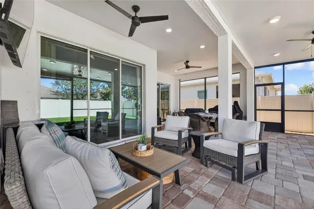 a living room with furniture and a floor to ceiling window
