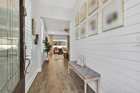 a view of a hallway with wooden floor and staircase