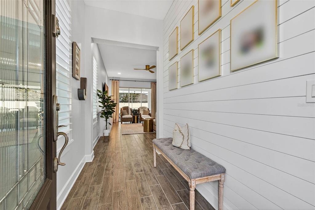 10522 Cardera Drive Riverview, FL 33578 - Photo 10 of 43 a view of a hallway with wooden floor and staircase