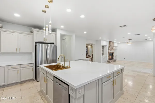 a view of a kitchen with refrigerator and fireplace