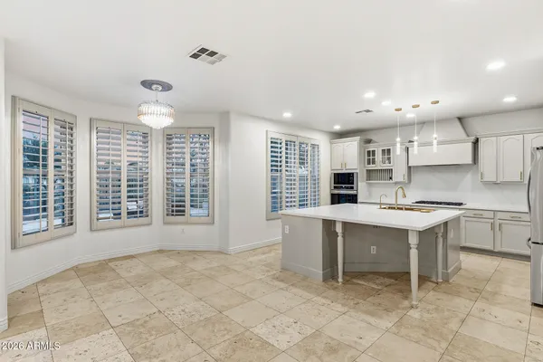 a kitchen with a sink and a stove top oven