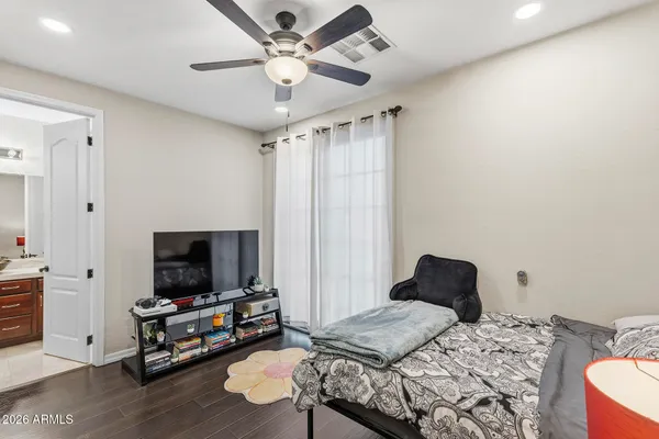 an empty room with a window and a ceiling fan