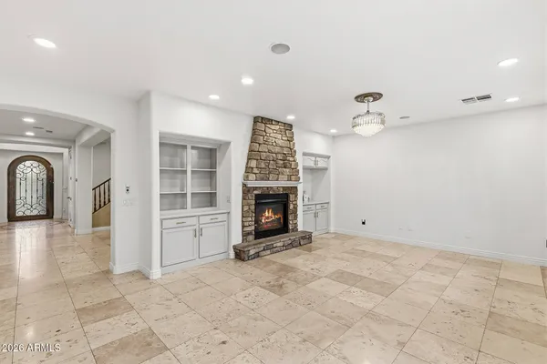 a living room with furniture and large windows