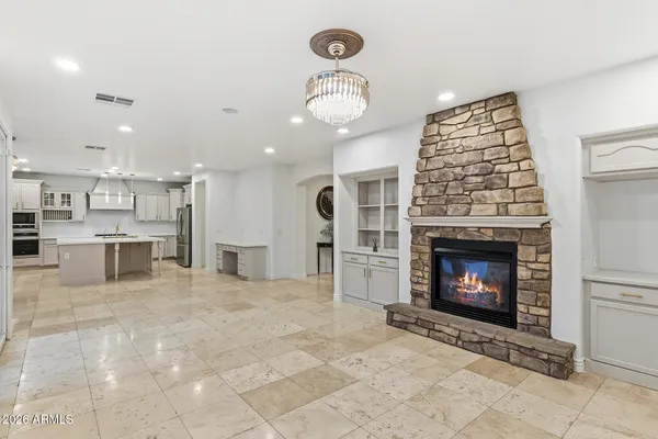 a view of a dining room with furniture and chandelier