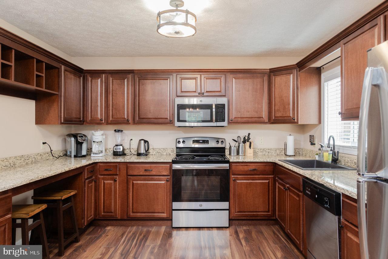 159 Park View Shenandoah, VA 22849 - Photo 12 of 66 a kitchen with stainless steel appliances granite countertop wooden cabinets a sink a stove a refrigerator and cabinets