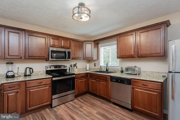 a kitchen with a sink and a stove top oven