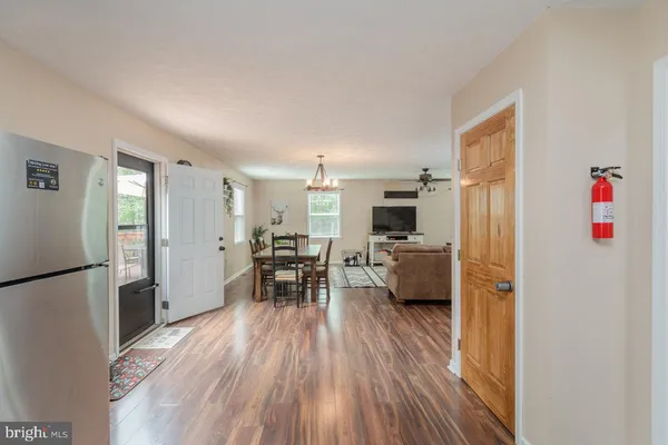 a bedroom with a bed and a chandelier fan