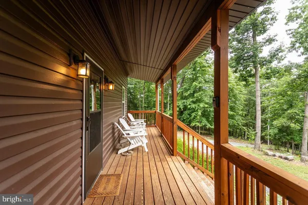 a living room with furniture flat screen tv and hard wood floor