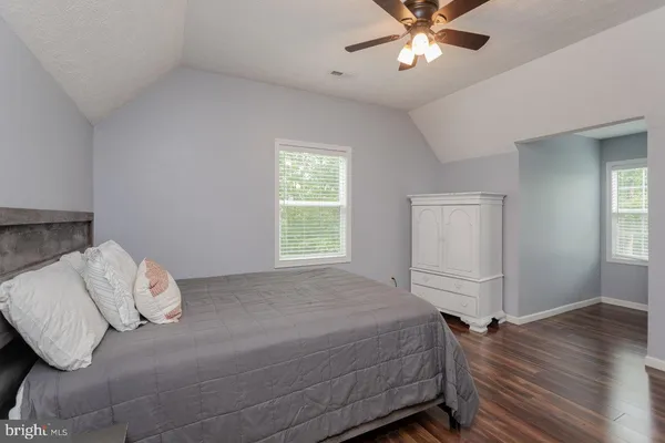 an aerial view of residential house with outdoor space and trees all around