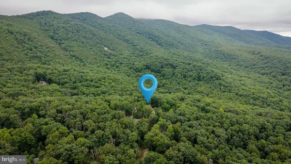 an aerial view of a house with swimming pool and garden