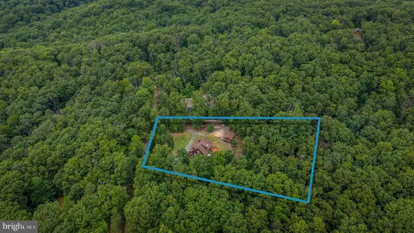 a view of a chairs and table in backyard