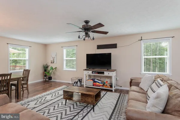 a living room with furniture a fireplace and a chandelier