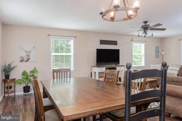 a kitchen with stainless steel appliances granite countertop wooden cabinets a sink a stove a refrigerator and cabinets