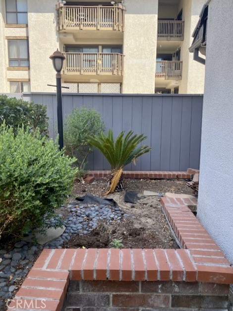 8105 Redlands Street, Unit 107 Playa del Rey, CA 90293 - Photo 36 of 43 a view of a brick house with a yard