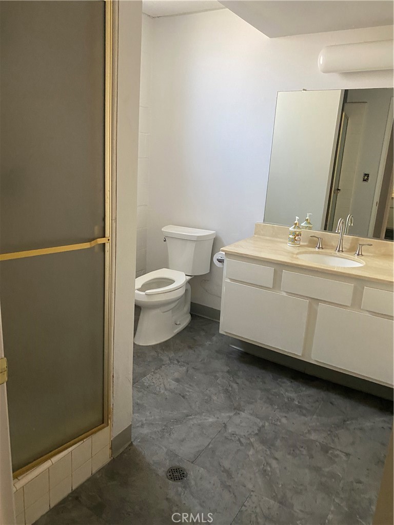 8105 Redlands Street, Unit 107 Playa del Rey, CA 90293 - Photo 39 of 43 a bathroom with a toilet a sink and mirror
