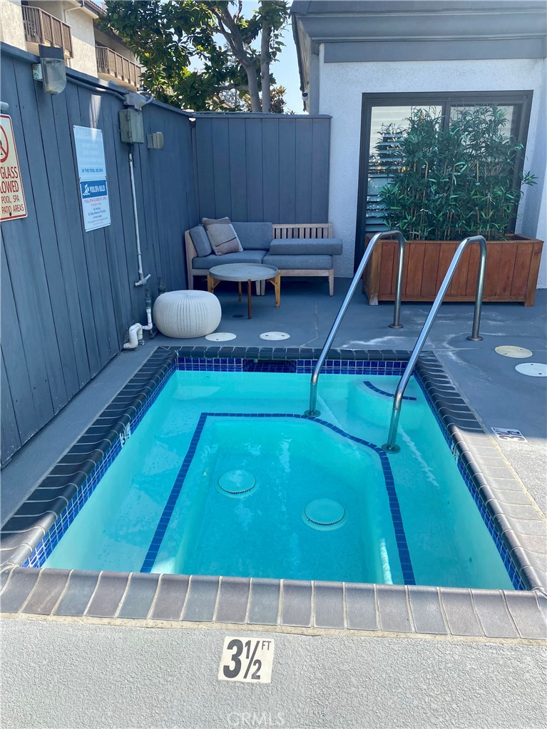 8105 Redlands Street, Unit 107 Playa del Rey, CA 90293 - Photo 4 of 43 a backyard of a house with table and chairs